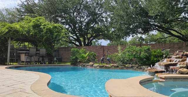 a view of a swimming pool with a patio