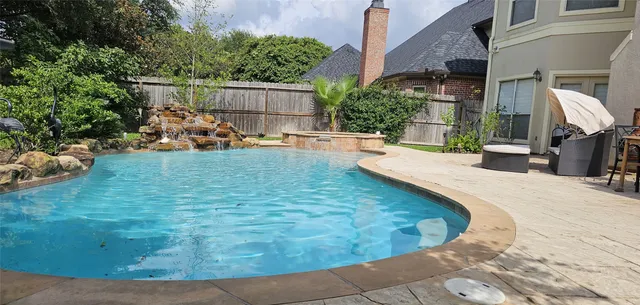 a view of a backyard with plants and patio