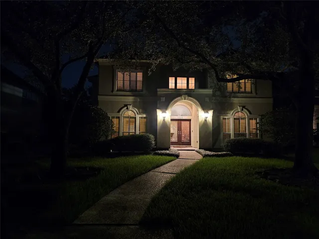 a front view of a house with garden