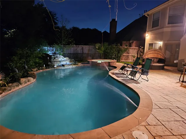 a view of a swimming pool with an outdoor seating