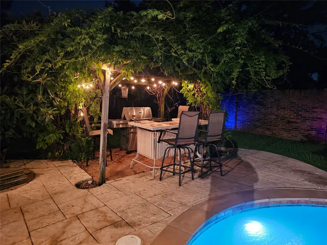 a view of a patio with table and chairs with wooden floor and fence