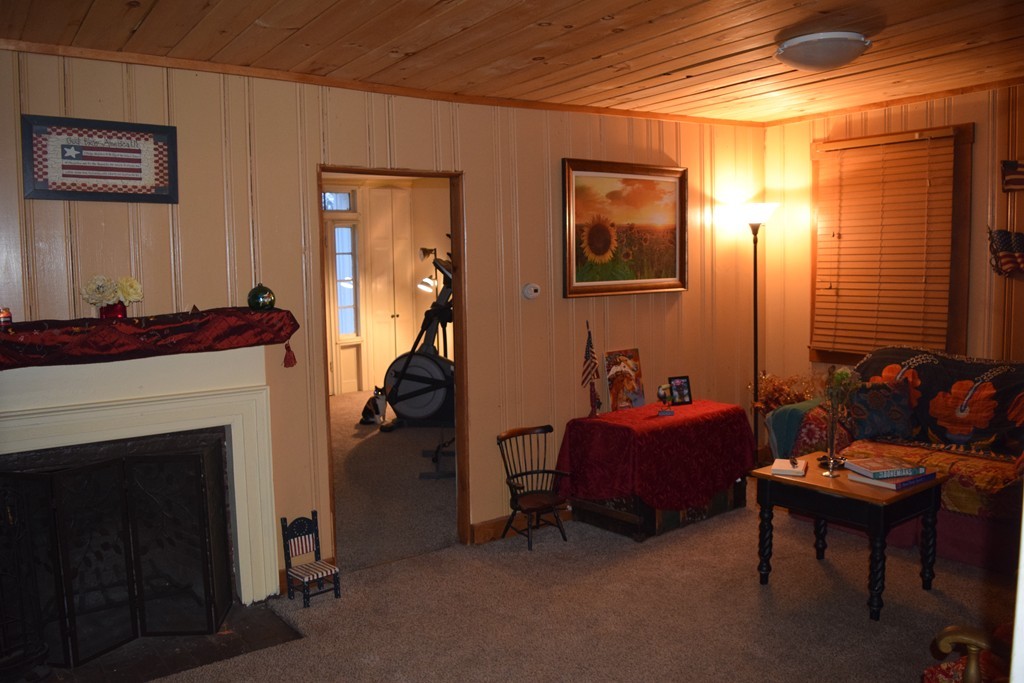 1572 Main Road Granville, MA 01034 - Photo 18 of 26 a living room with furniture and a fireplace