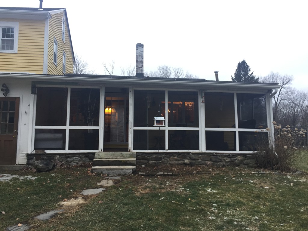 1572 Main Road Granville, MA 01034 - Photo 3 of 26 a front view of a house with glass windows
