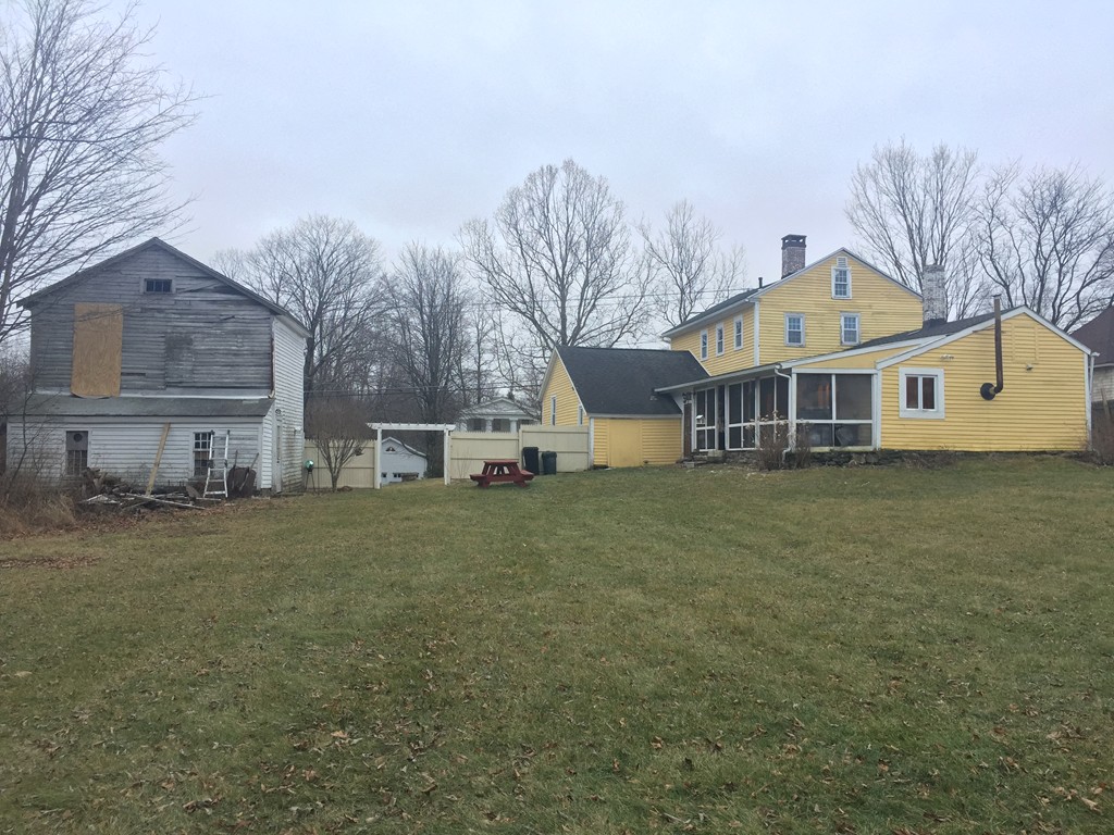 1572 Main Road Granville, MA 01034 - Photo 5 of 26 a front view of a house with a yard