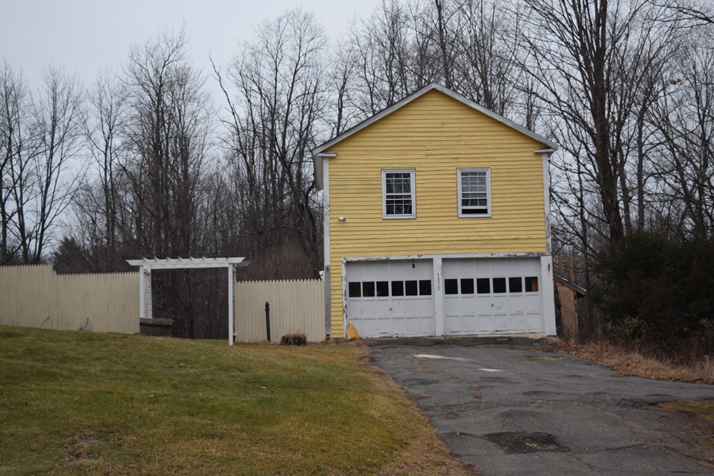 1572 Main Road Granville, MA 01034 - Photo 8 of 26 a front view of a house with a yard and garage