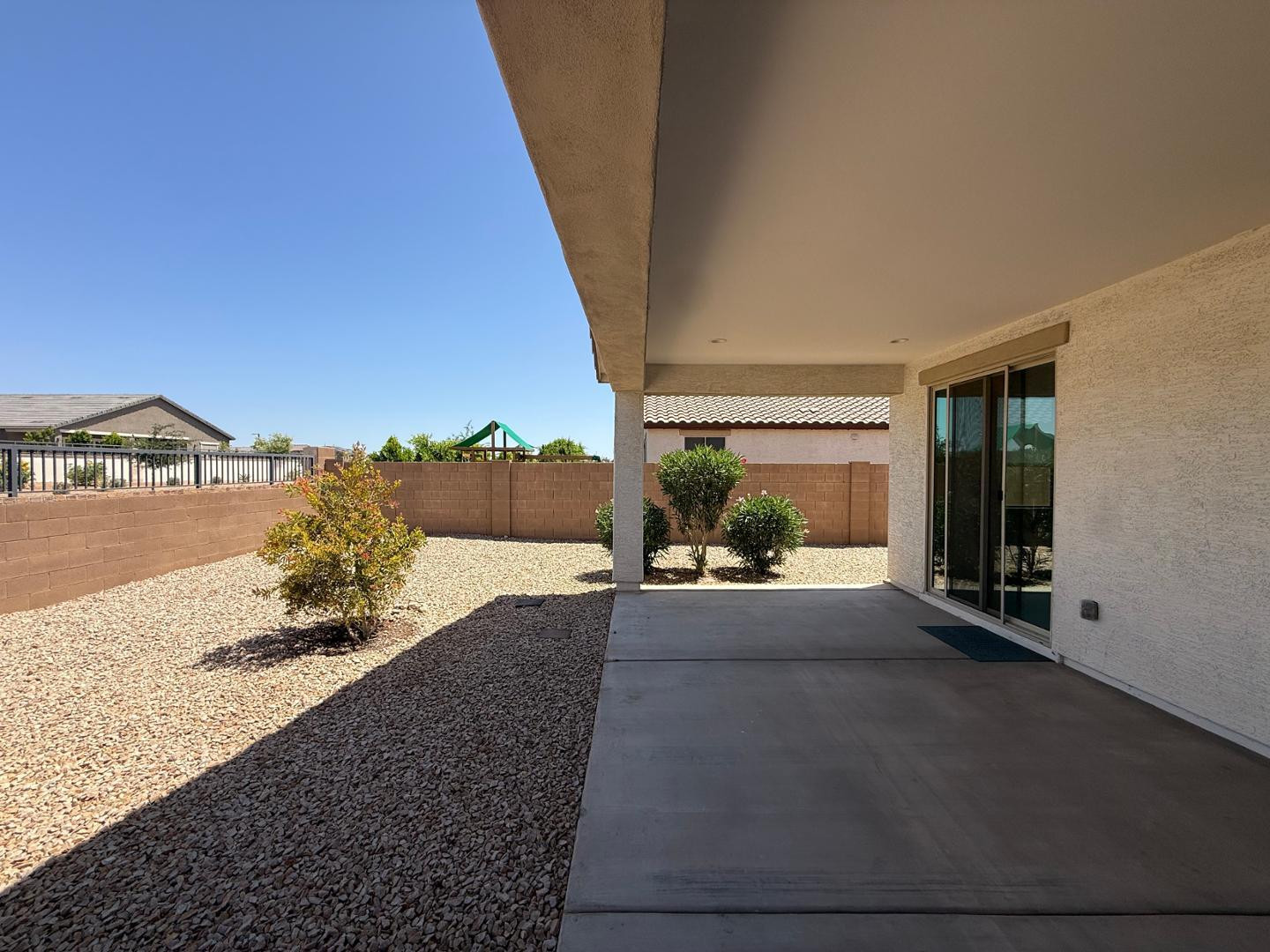 15744 West Jefferson Street Goodyear, AZ 85338 - Photo 24 of 26 a view of a house with a floor to ceiling window and potted plants
