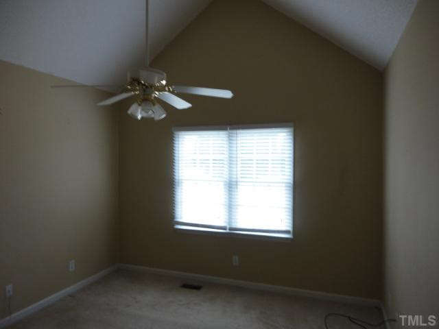 10020 Kennebec Road Willow Spring, NC 27592 - Photo 2 of 7 an empty room with a window