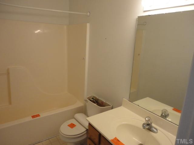 10020 Kennebec Road Willow Spring, NC 27592 - Photo 3 of 7 a bathroom with a sink a toilet and shower