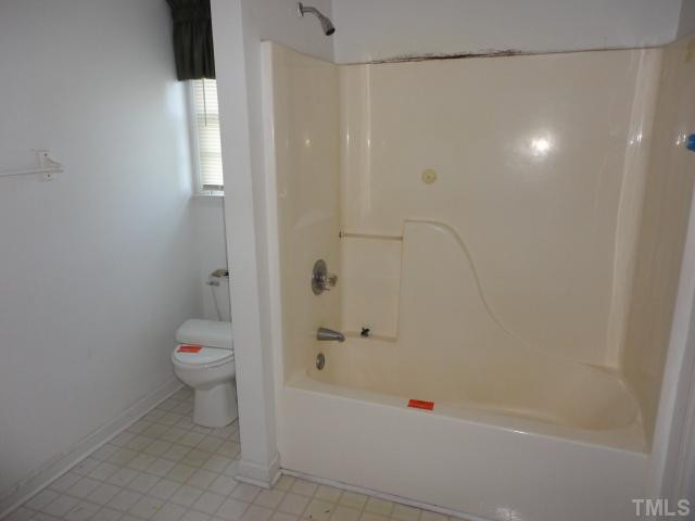 10020 Kennebec Road Willow Spring, NC 27592 - Photo 5 of 7 a bathroom with a shower a toilet and a shower