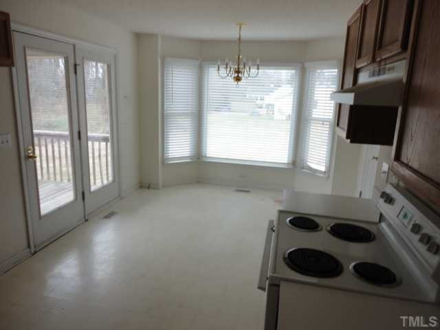 10020 Kennebec Road Willow Spring, NC 27592 - Photo 7 of 7 a kitchen with a sink a window and stainless steel appliances