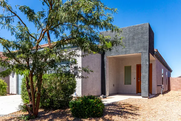 a view of a house with a tree