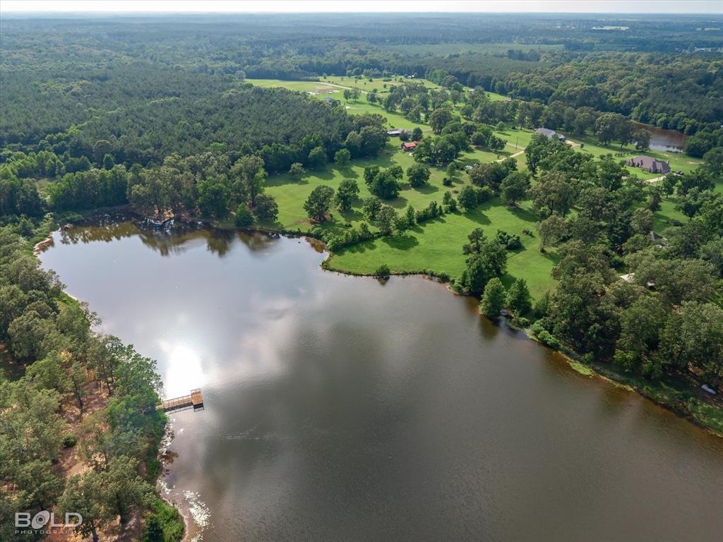 0 Twin Lakes Road Mansfield, LA 71052 - Photo 23 of 28 Expansive aerial view showcasing a large body of water with a dock, surrounded by mature trees and lush green fields