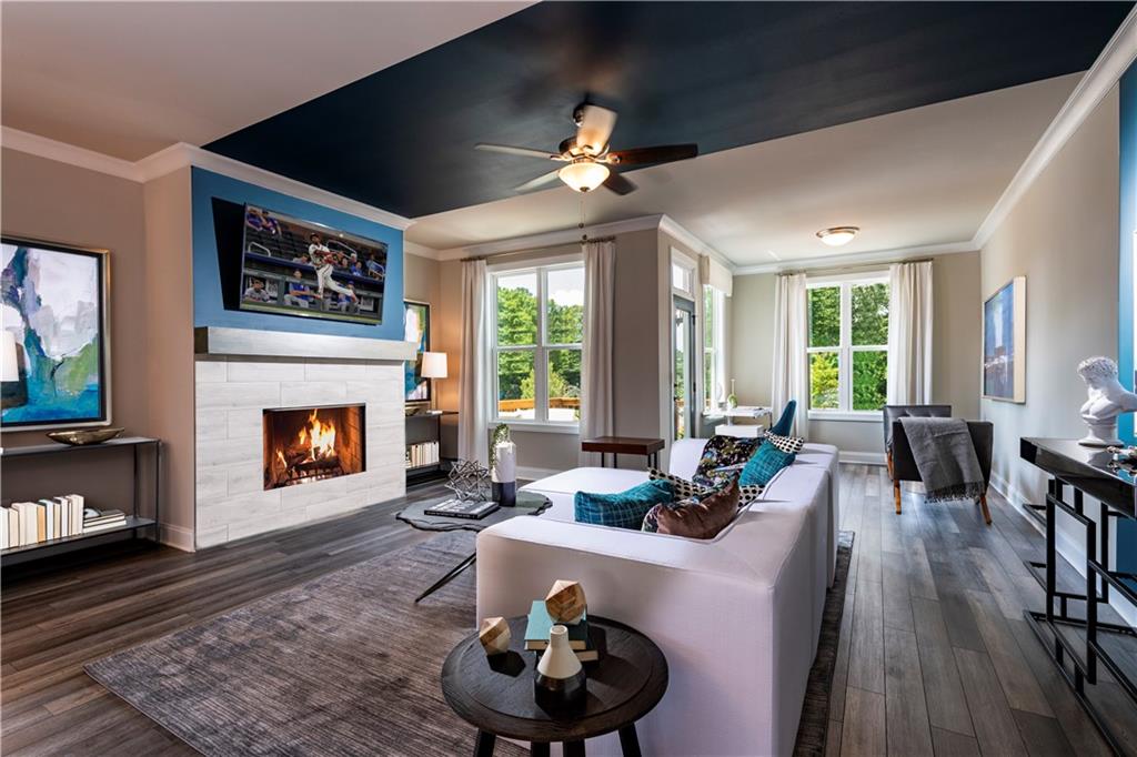 a living room with furniture a fireplace and a flat screen tv