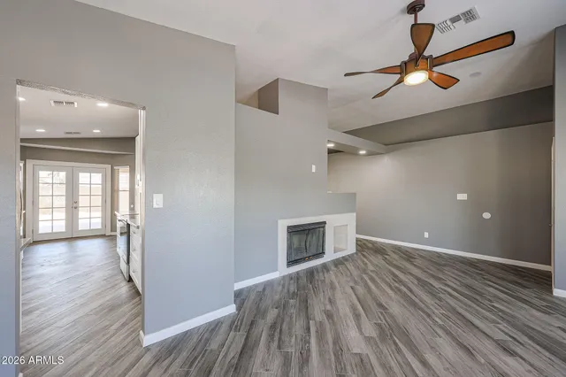 a kitchen with stainless steel appliances granite countertop a sink a stove and a wooden floors