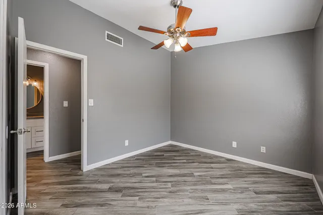 a view of a room with a ceiling fan and a window
