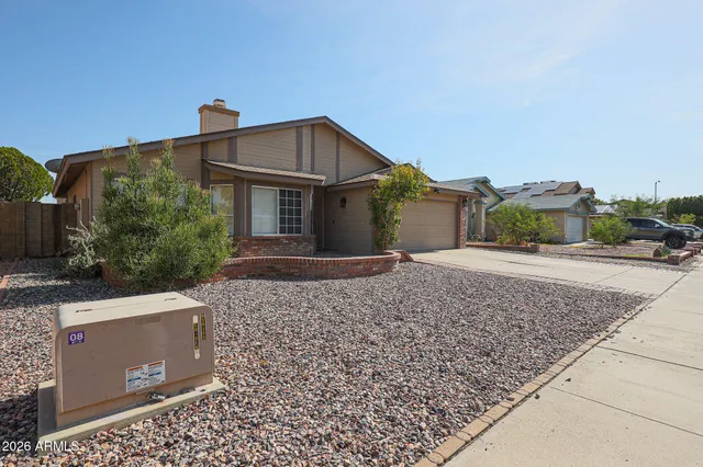 a view of a kitchen with a fridge wooden floor and a ceiling fan