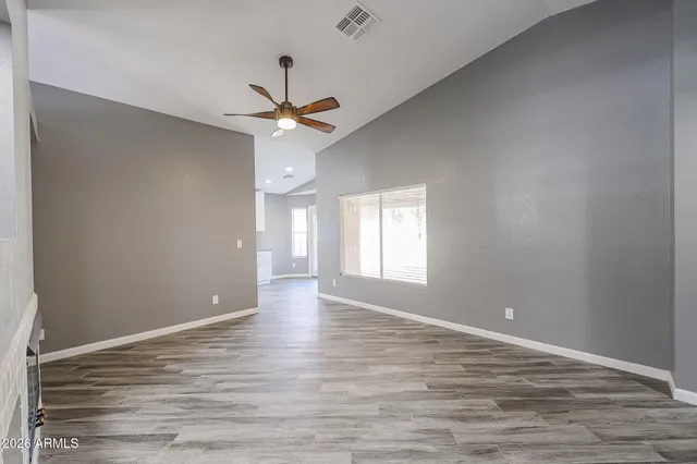 wooden floor in an empty room with a window