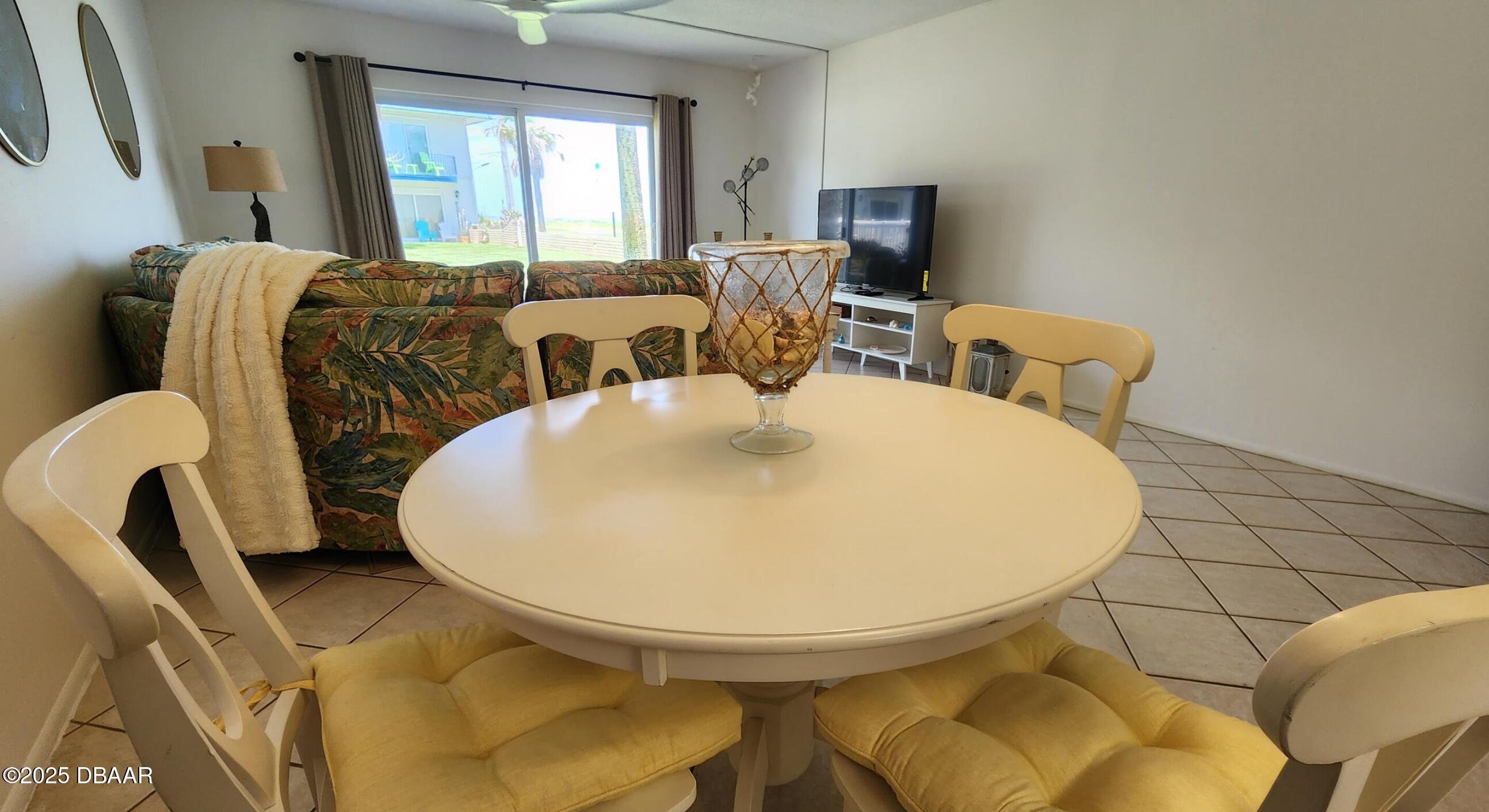 2750 Ocean Shore Boulevard, Unit 8 Ormond Beach, FL 32176 - Photo 11 of 60 a living room with furniture and a fireplace