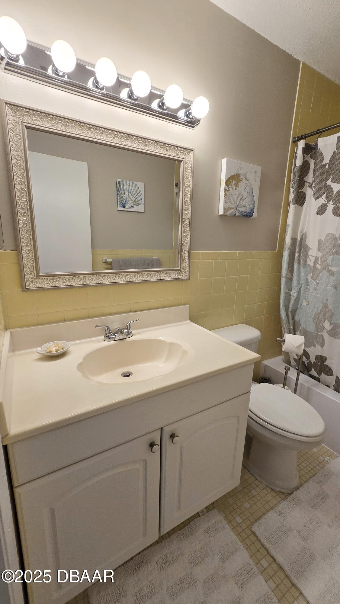 2750 Ocean Shore Boulevard, Unit 8 Ormond Beach, FL 32176 - Photo 13 of 60 a bathroom with a sink and a mirror