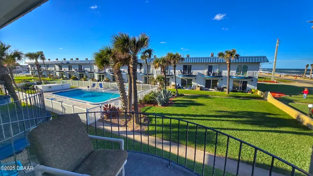 a bedroom with two beds and wooden floor
