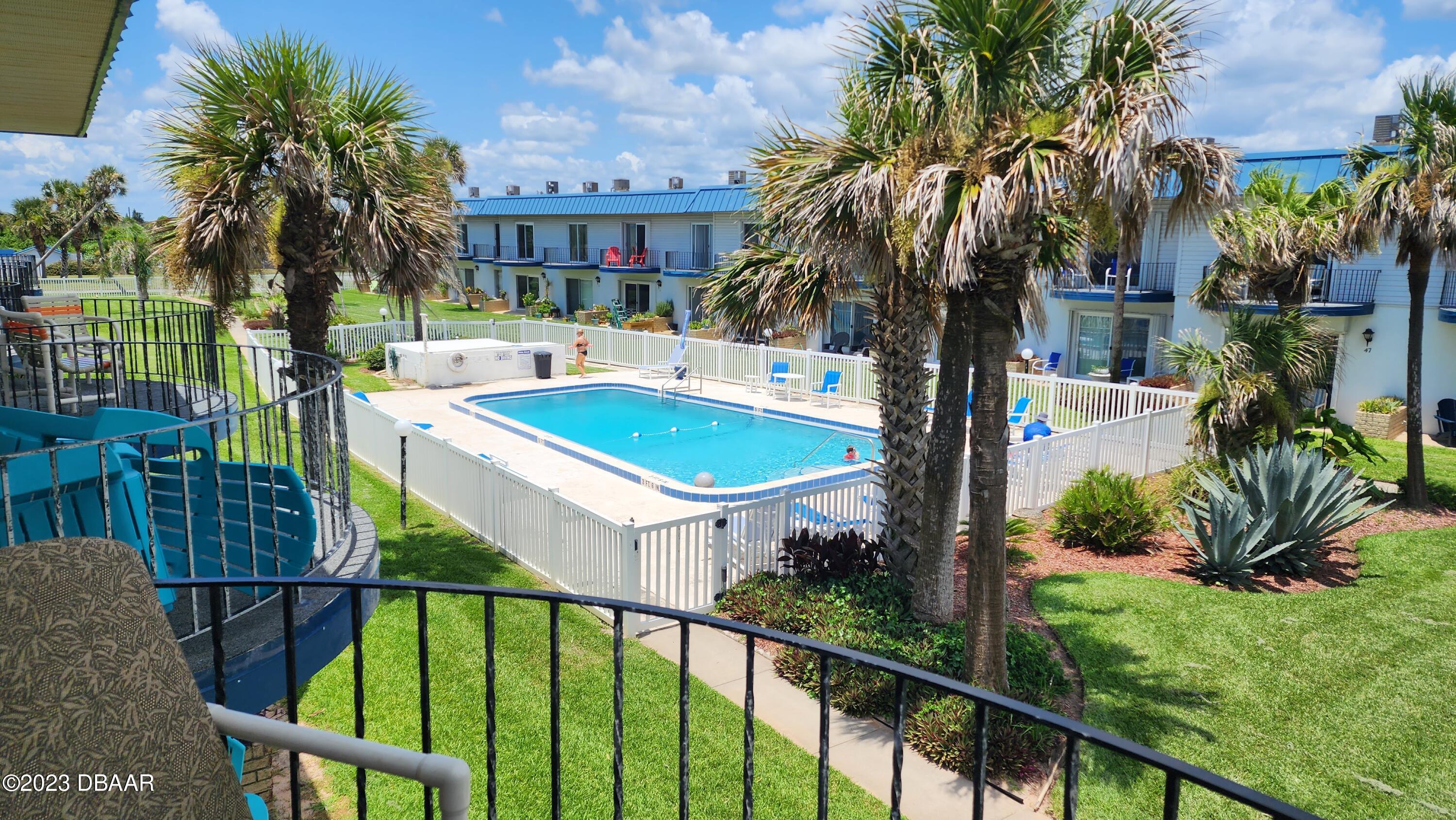 2750 Ocean Shore Boulevard, Unit 8 Ormond Beach, FL 32176 - Photo 29 of 60 a view of a house with backyard and sitting area