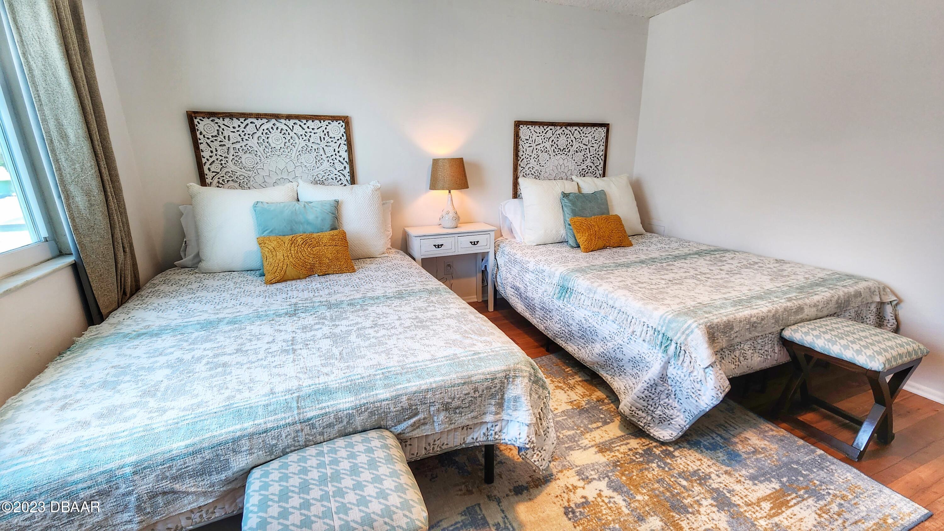 2750 Ocean Shore Boulevard, Unit 8 Ormond Beach, FL 32176 - Photo 33 of 60 a bedroom with a bed and dresser