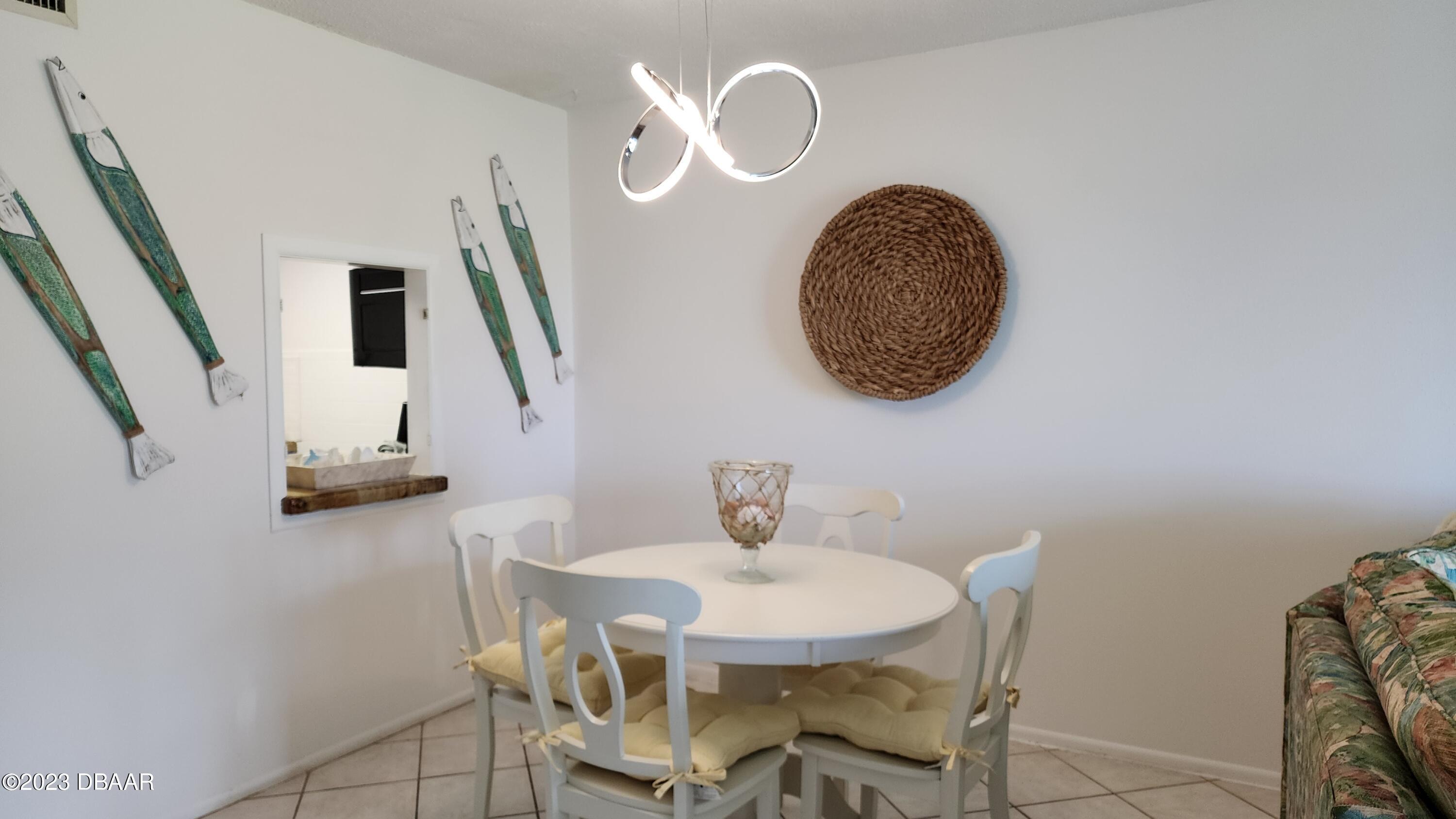2750 Ocean Shore Boulevard, Unit 8 Ormond Beach, FL 32176 - Photo 38 of 60 a view of a dining room with furniture and a mirror
