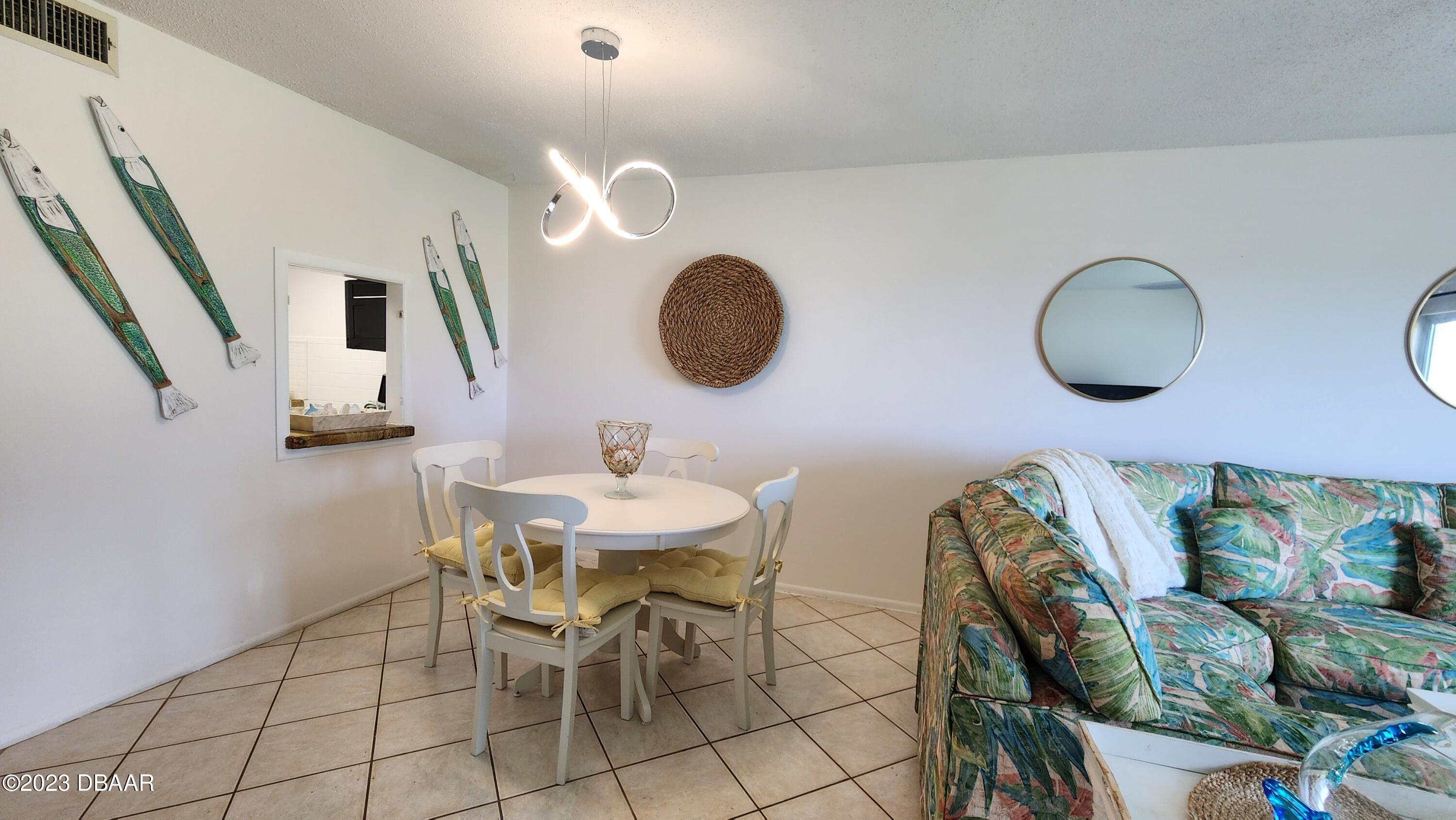 2750 Ocean Shore Boulevard, Unit 8 Ormond Beach, FL 32176 - Photo 39 of 60 a view of livingroom and dining room with furniture