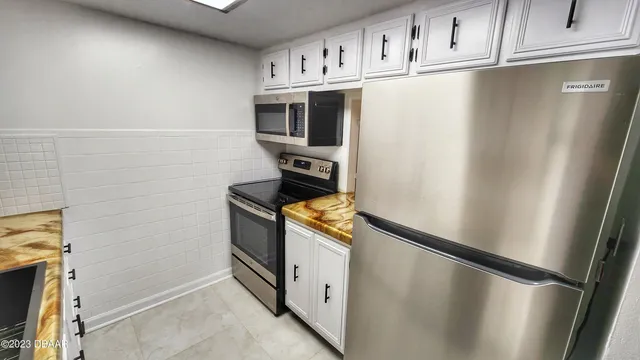 a bathroom with a sink a toilet a shower and a mirror