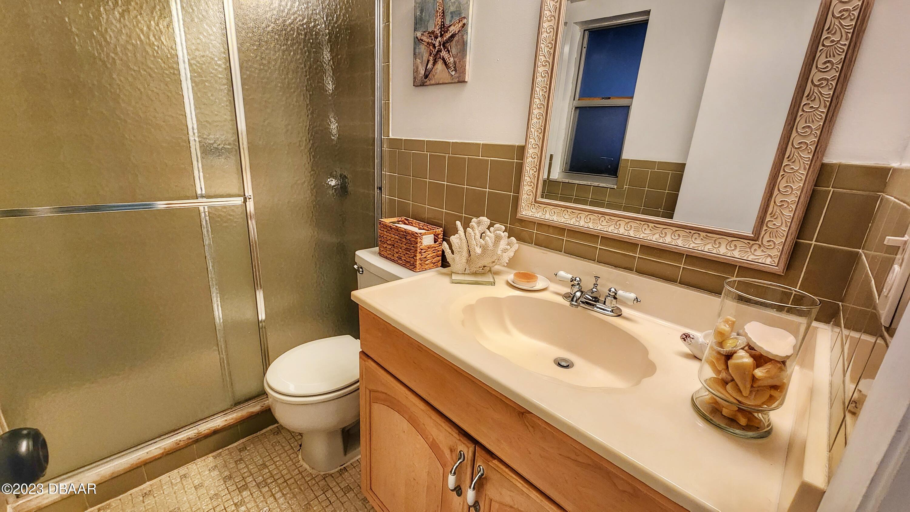 2750 Ocean Shore Boulevard, Unit 8 Ormond Beach, FL 32176 - Photo 49 of 60 a bathroom with a sink toilet and shower
