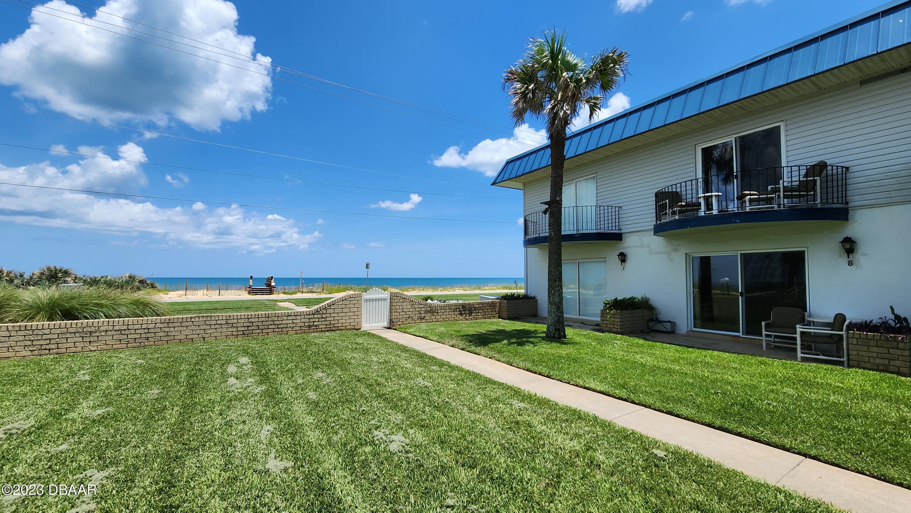 2750 Ocean Shore Boulevard, Unit 8 Ormond Beach, FL 32176 - Photo 51 of 60 a view of a house with a yard