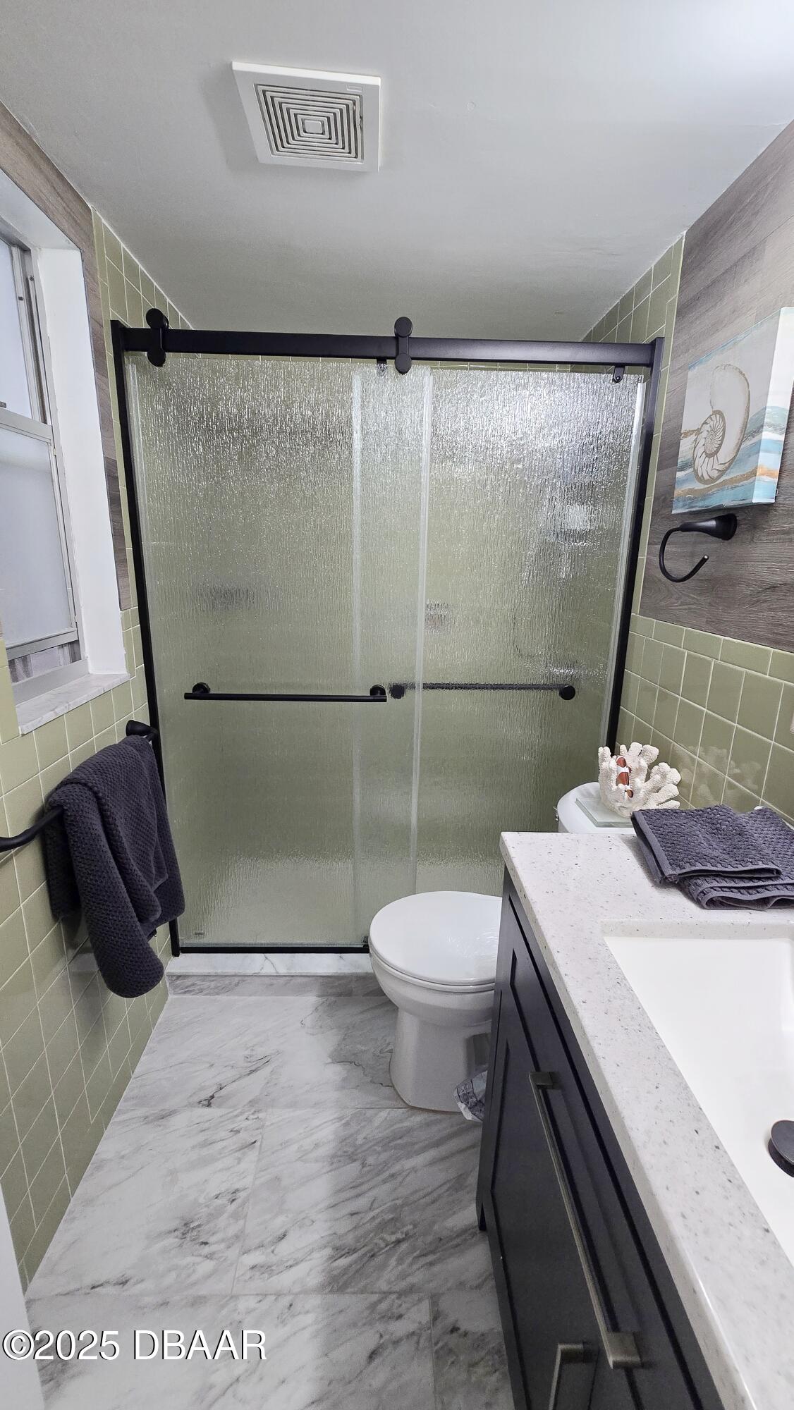 2750 Ocean Shore Boulevard, Unit 8 Ormond Beach, FL 32176 - Photo 54 of 60 a bathroom with a sink a toilet a mirror and shower