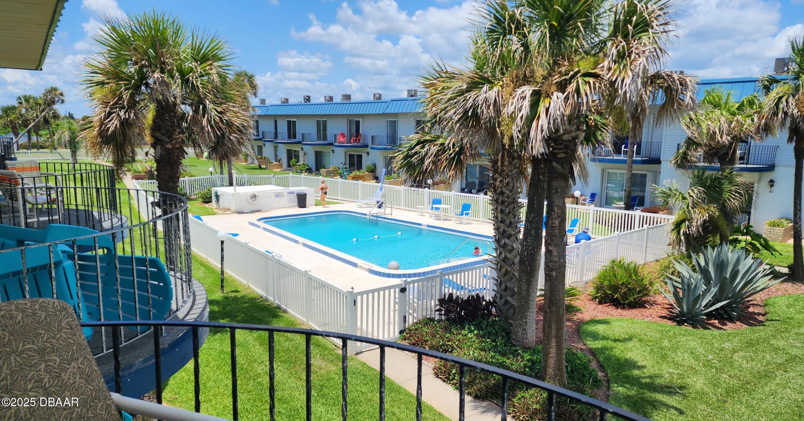 2750 Ocean Shore Boulevard, Unit 8 Ormond Beach, FL 32176 - Photo 58 of 60 a view of a house with backyard and sitting area