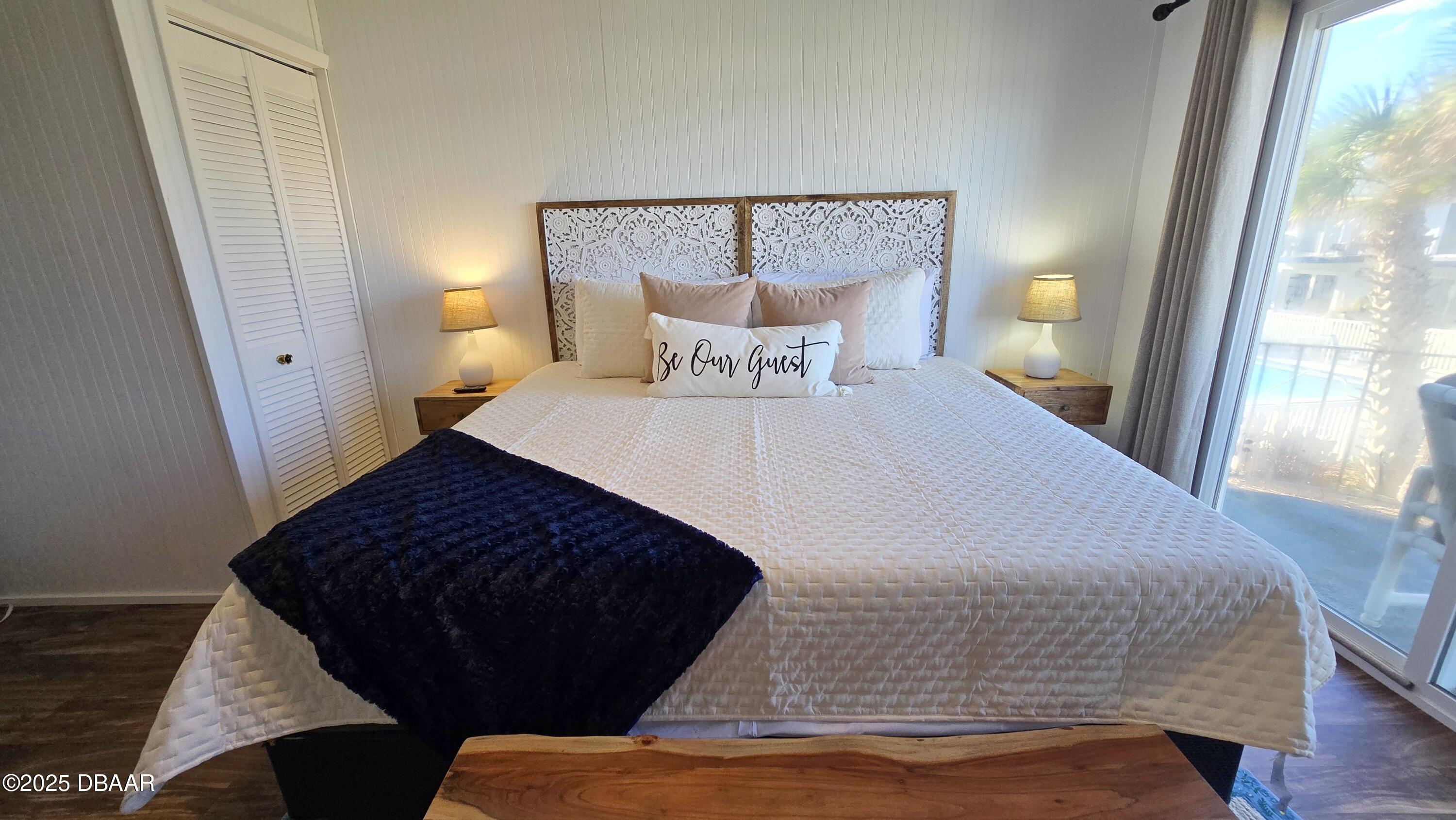 2750 Ocean Shore Boulevard, Unit 8 Ormond Beach, FL 32176 - Photo 7 of 60 a large bed sitting in a bedroom next to a window