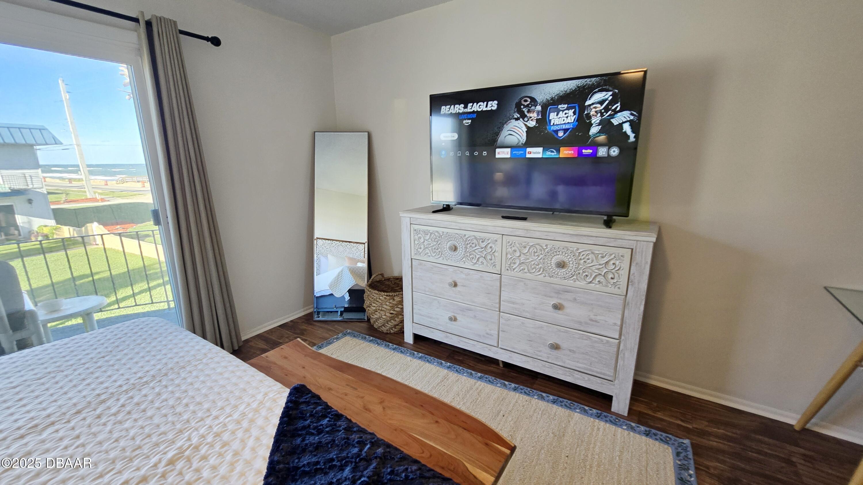 2750 Ocean Shore Boulevard, Unit 8 Ormond Beach, FL 32176 - Photo 8 of 60 a bedroom with a bed and furniture