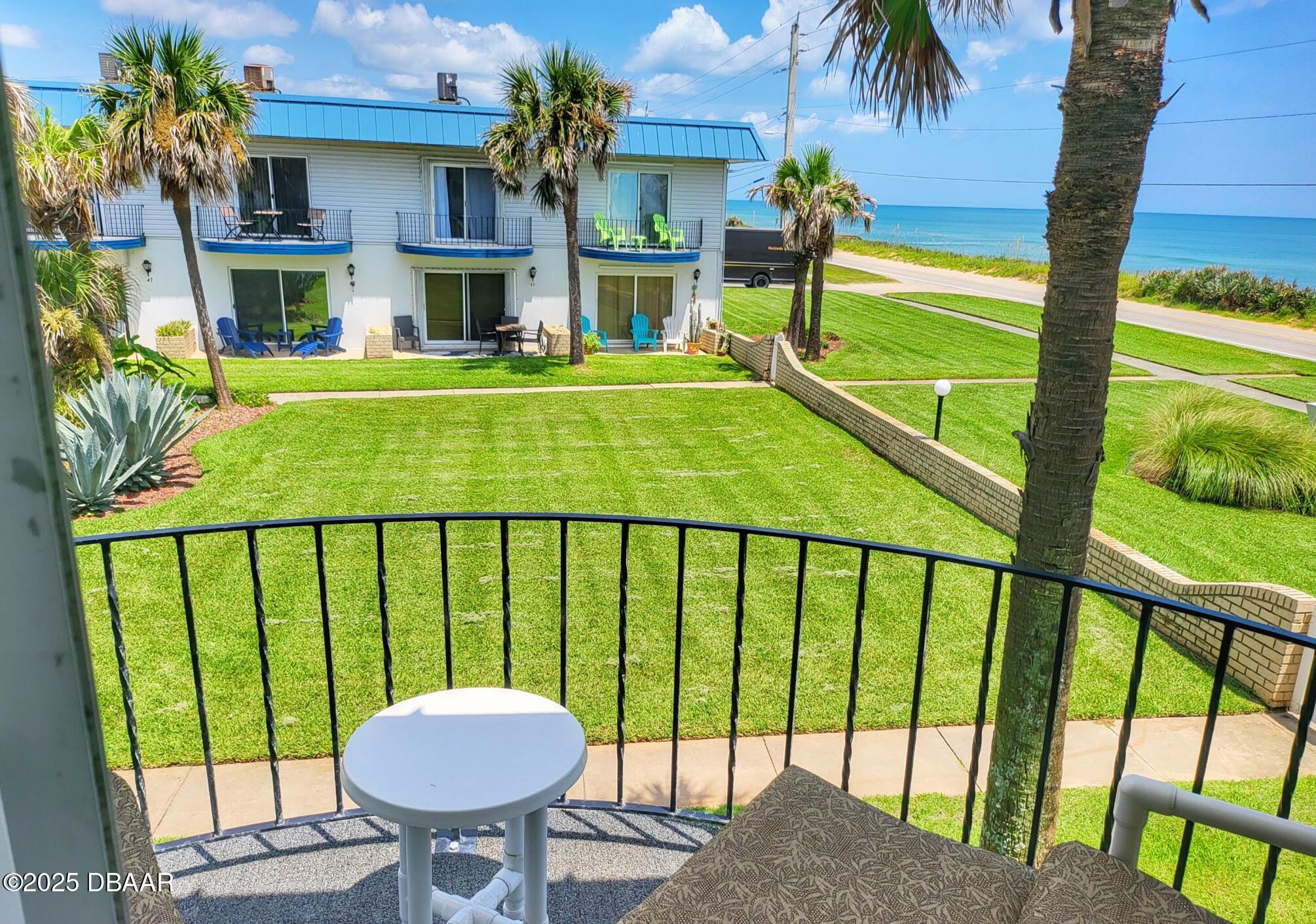 2750 Ocean Shore Boulevard, Unit 8 Ormond Beach, FL 32176 - Photo 9 of 60 a view of a balcony with a table and chairs