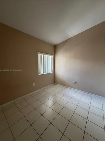 a view of an empty room and wooden floor
