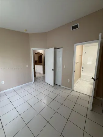 a bathroom with a granite countertop sink toilet a mirror and shower