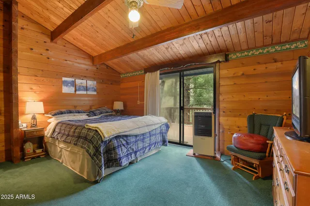 a spacious bedroom with a bed and wooden floor