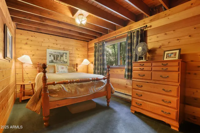 a bed sitting in a room next to a window