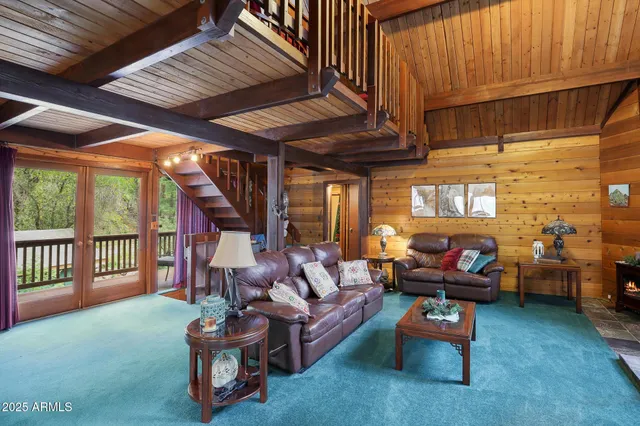 a living room with furniture a fireplace and a table