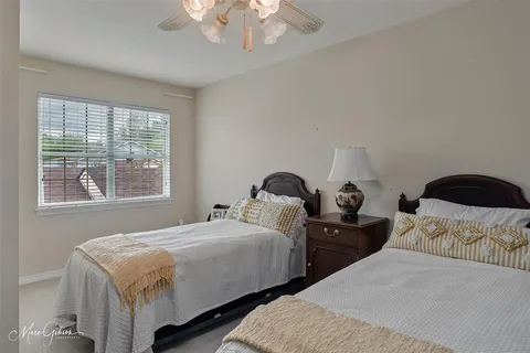 a bedroom with two beds and a chandelier