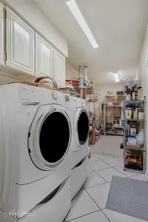 a utility room with sink dryer and washer