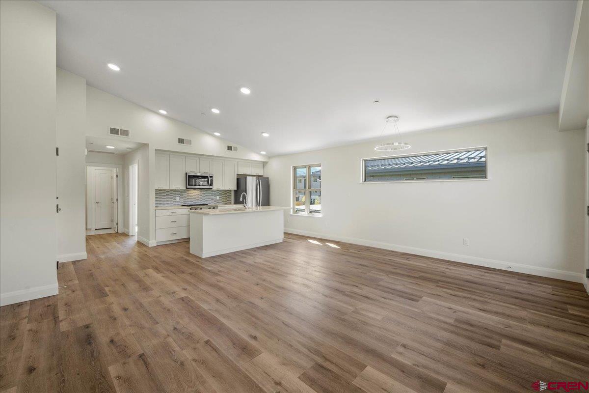 199 Riverfront Lane, Unit 200 Ridgway, CO 81432 - Photo 18 of 28 a view of a kitchen with wooden floor and a kitchen