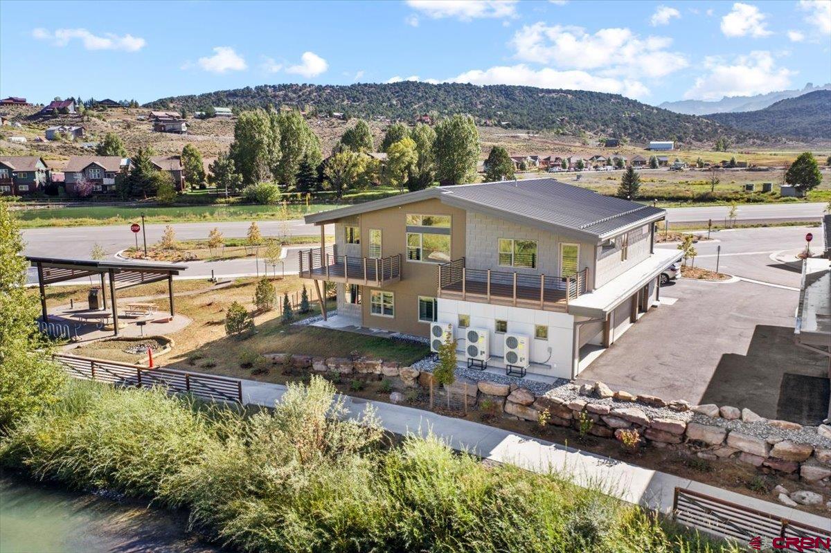 199 Riverfront Lane, Unit 200 Ridgway, CO 81432 - Photo 23 of 28 a view of a lake with a mountain in the background