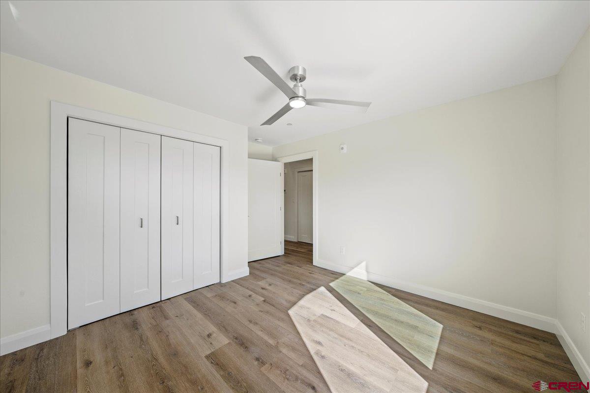 199 Riverfront Lane, Unit 200 Ridgway, CO 81432 - Photo 25 of 28 a view of a bedroom with wooden floor