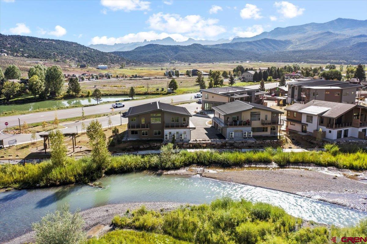 199 Riverfront Lane, Unit 200 Ridgway, CO 81432 - Photo 26 of 28 a view of a lake with a building in front of it