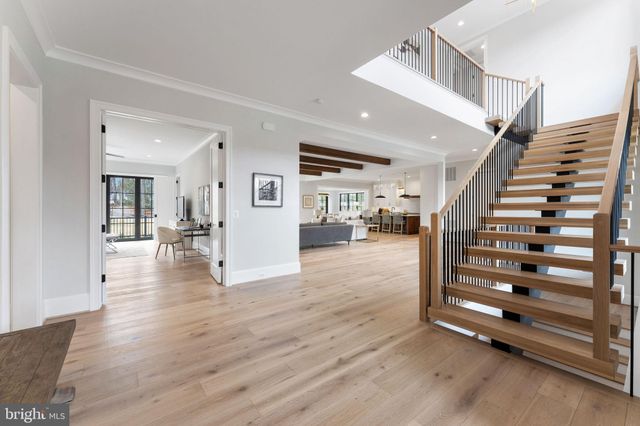 a large white open kitchen with stainless steel appliances granite countertop a lot of counter space