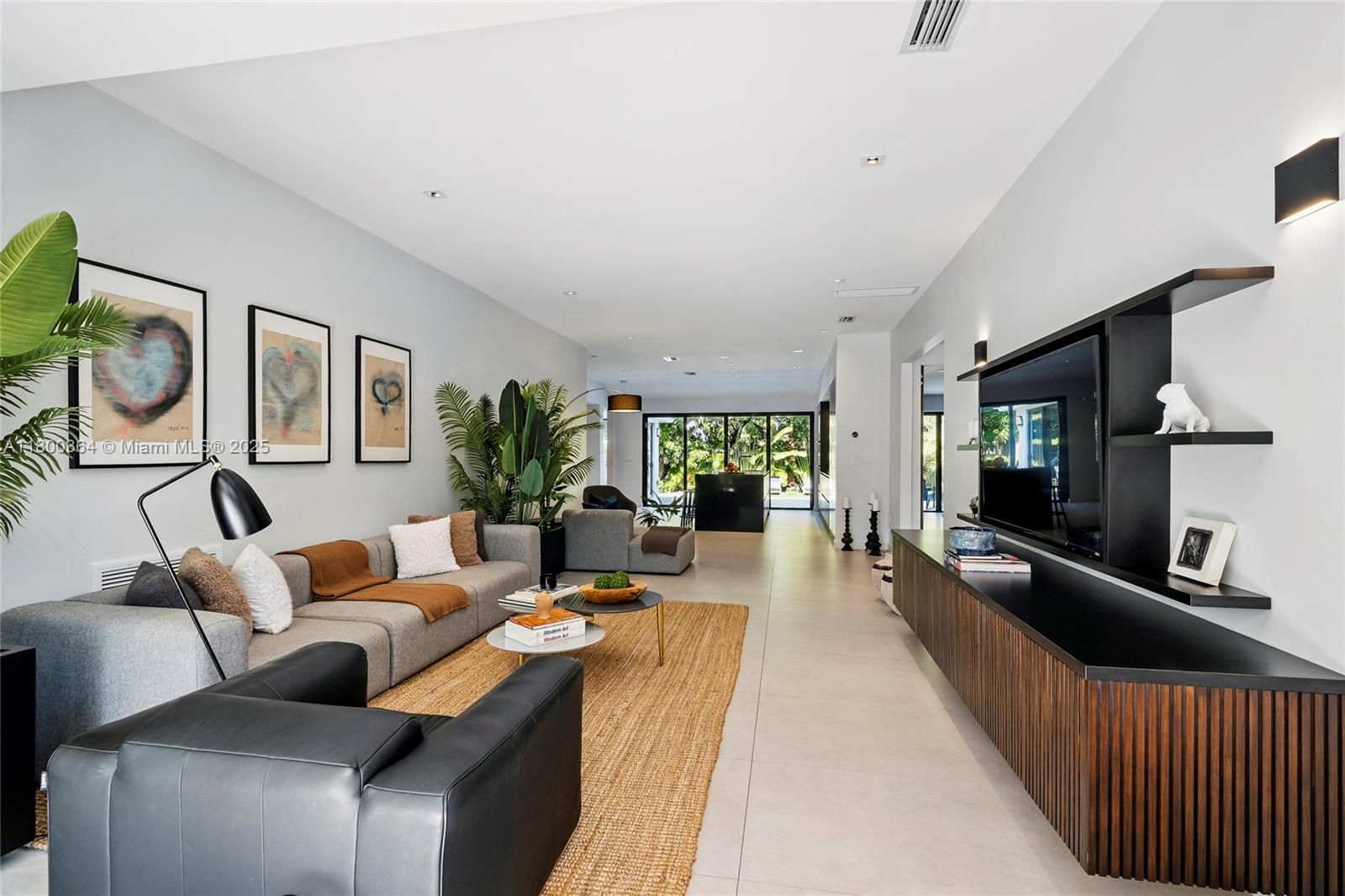 4275 Prairie Avenue Miami Beach, FL 33140 - Photo 17 of 61 a living room with furniture and a flat screen tv