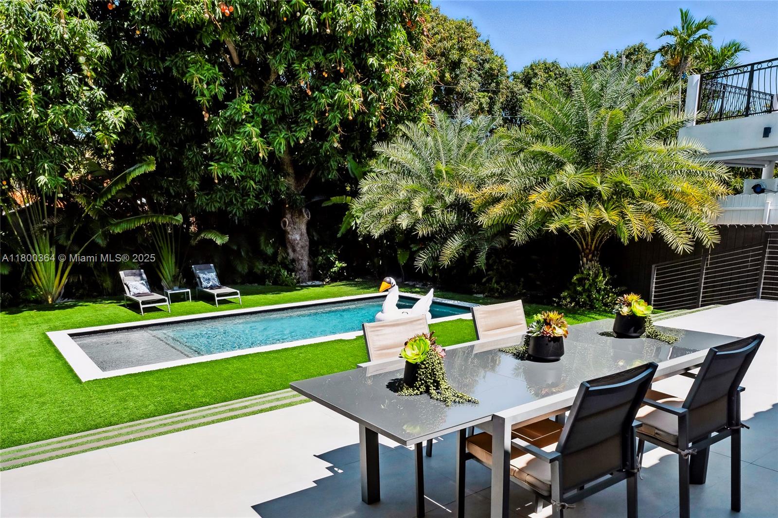 4275 Prairie Avenue Miami Beach, FL 33140 - Photo 25 of 61 a view of a chairs and table in a backyard